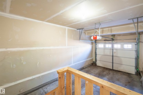 Garage featuring a garage door opener - 13 5317 3 Avenue, Edmonton, AB - Indoor Photo Showing Garage