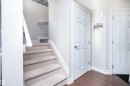 Stairway featuring baseboards and wood finished floors - 13 5317 3 Avenue, Edmonton, AB  - Indoor Photo Showing Other Room 