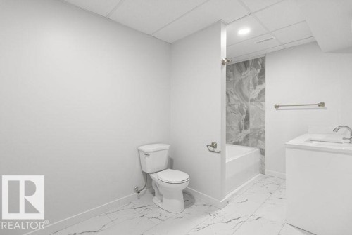 Bathroom featuring vanity, a drop ceiling, light marble finish flooring, shower / washtub combination, and recessed lighting - 875 Juniper Avenue, Sherwood Park, AB - Indoor Photo Showing Bathroom
