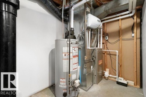 Utilities featuring gas water heater and heating unit - 875 Juniper Avenue, Sherwood Park, AB - Indoor Photo Showing Basement