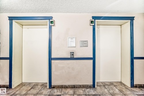 Detailed view of elevator and a textured ceiling - 108 10535 122 Street, Edmonton, AB - Indoor