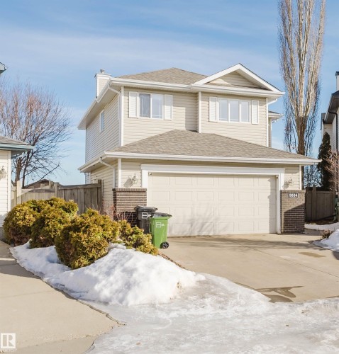 View of front of house with brick siding, concrete driveway, a garage, and a chimney - 3534 Mclean Crescent, Edmonton, AB - Outdoor