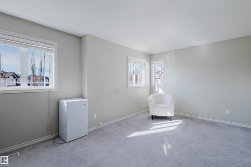 Living area with carpet flooring and baseboards - 3534 Mclean Crescent, Edmonton, AB - Indoor