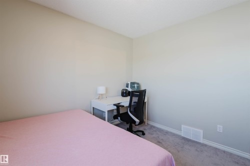 Bedroom featuring a desk, carpet, and a textured ceiling - 3534 Mclean Crescent, Edmonton, AB - Indoor Photo Showing Bedroom