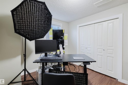 Home office featuring wood finished floors and a textured ceiling - 3534 Mclean Crescent, Edmonton, AB - Indoor