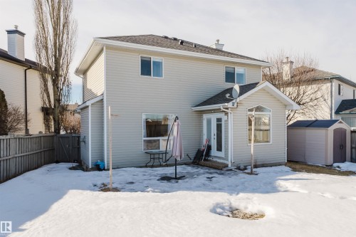 Snow covered property featuring a shed and a shingled roof - 3534 Mclean Crescent, Edmonton, AB - Outdoor With Exterior