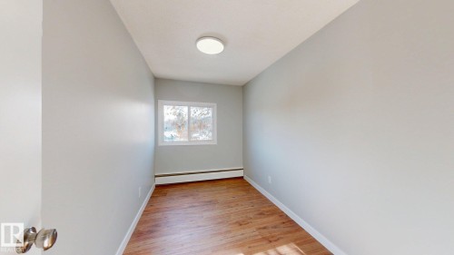 Unfurnished room with light wood-style flooring and baseboard heating - 611 2908 116A Avenue, Edmonton, AB - Indoor Photo Showing Other Room