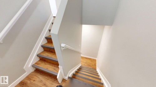 Staircase with wood finished floors - 611 2908 116A Avenue, Edmonton, AB - Indoor Photo Showing Other Room
