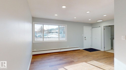Entryway featuring light wood-type flooring, a baseboard heating unit, and recessed lighting - 611 2908 116A Avenue, Edmonton, AB - Indoor Photo Showing Other Room