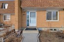Entrance to property featuring brick siding, a shingled roof, and mansard roof - 180 Londonderry Square, Edmonton, AB  - Outdoor With Exterior 