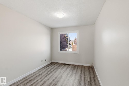 Spare room featuring light wood-type flooring and a textured ceiling - 180 Londonderry Square, Edmonton, AB - Indoor Photo Showing Other Room