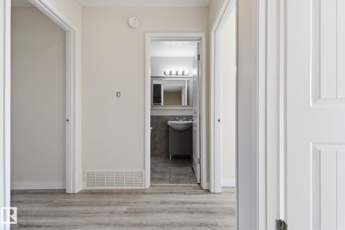 Hallway featuring light wood-style flooring and a sink - 180 Londonderry Square, Edmonton, AB - Indoor Photo Showing Other Room