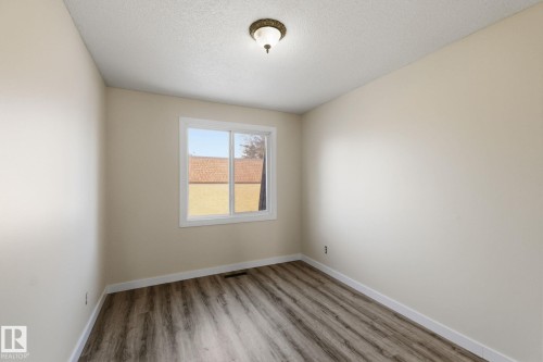 Unfurnished room featuring light wood-type flooring and a textured ceiling - 180 Londonderry Square, Edmonton, AB - Indoor Photo Showing Other Room