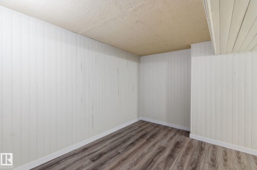 Empty room with wood finished floors and a textured ceiling - 180 Londonderry Square, Edmonton, AB - Indoor Photo Showing Other Room