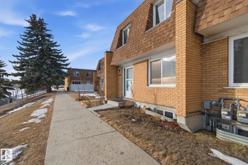 View of front of home featuring brick siding, mansard roof, and a shingled roof - 180 Londonderry Square, Edmonton, AB - Outdoor