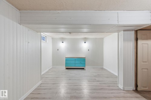 Finished below grade area with light wood-style floors and baseboards - 180 Londonderry Square, Edmonton, AB - Indoor Photo Showing Other Room