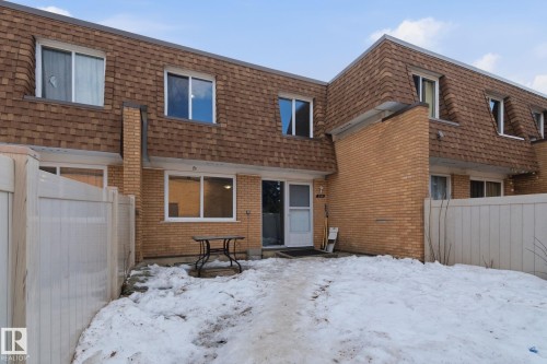 Snow covered house with mansard roof, brick siding, and roof with shingles - 180 Londonderry Square, Edmonton, AB - Outdoor With Exterior