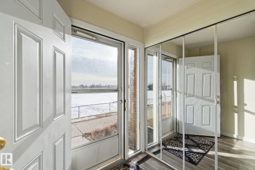 Doorway to outside featuring a water view and wood finished floors - 180 Londonderry Square, Edmonton, AB - Indoor Photo Showing Other Room