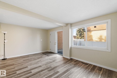 Spare room featuring wood finished floors and beamed ceiling - 180 Londonderry Square, Edmonton, AB - Indoor Photo Showing Other Room