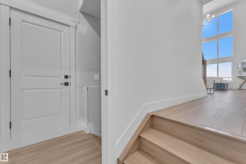 Staircase with wood finished floors and a high ceiling - 228 Linden Loop, Leduc, AB - Indoor Photo Showing Other Room