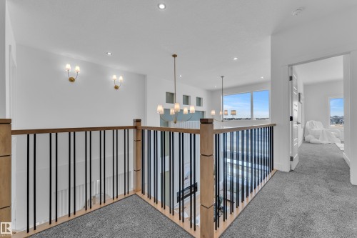 Corridor featuring carpet flooring and suspended lighting - 228 Linden Loop, Leduc, AB - Indoor Photo Showing Other Room