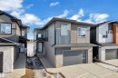 Contemporary house with an attached garage, stone siding, and driveway - 228 Linden Loop, Leduc, AB  - Outdoor With Facade 