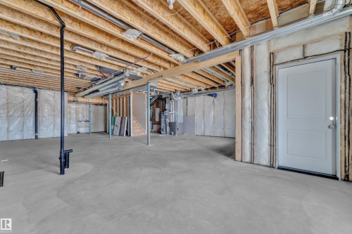 Unfinished basement featuring heating unit - 228 Linden Loop, Leduc, AB - Indoor Photo Showing Basement