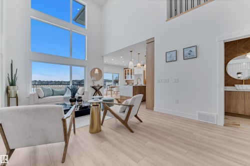 Living area featuring light wood-style flooring and a high ceiling - 228 Linden Loop, Leduc, AB - Indoor