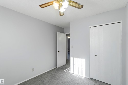 Unfurnished bedroom with carpet, a closet, and a ceiling fan - 135 Humberstone Road, Edmonton, AB - Indoor Photo Showing Other Room