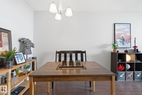 Dining area with wood finished floors and a chandelier - 1312 13910 Stony Plain Road, Edmonton, AB - Indoor