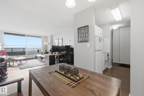 Living room featuring an office area, dark wood-style flooring, and a textured ceiling - 1312 13910 Stony Plain Road, Edmonton, AB - Indoor Photo Showing Living Room