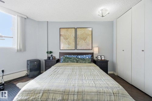 Bedroom with dark wood finished floors and a textured ceiling - 1312 13910 Stony Plain Road, Edmonton, AB - Indoor Photo Showing Bedroom