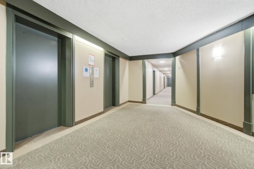 Hallway with carpet floors, elevator, and a textured ceiling - 1312 13910 Stony Plain Road, Edmonton, AB -  Photo Showing Other Room