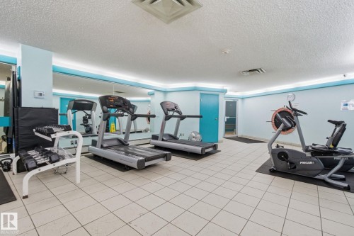 Exercise room with a textured ceiling and cooling unit - 1312 13910 Stony Plain Road, Edmonton, AB - Indoor Photo Showing Gym Room