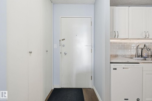 Doorway with wood finished floors and a textured ceiling - 1312 13910 Stony Plain Road, Edmonton, AB - Indoor