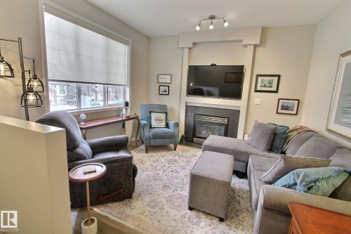 26 4821 Terwillegar Common, Edmonton, AB - Indoor Photo Showing Living Room With Fireplace