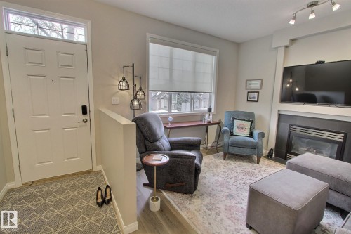 26 4821 Terwillegar Common, Edmonton, AB - Indoor Photo Showing Living Room With Fireplace