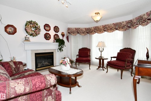 5 102 Bridgeport Crossing, Leduc, AB - Indoor Photo Showing Living Room With Fireplace