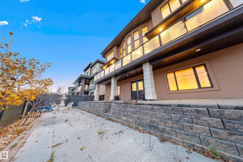 View of side of home featuring a patio area, a balcony, and stucco siding - 4811 Woolsey Lane, Edmonton, AB - Outdoor With Deck Patio Veranda