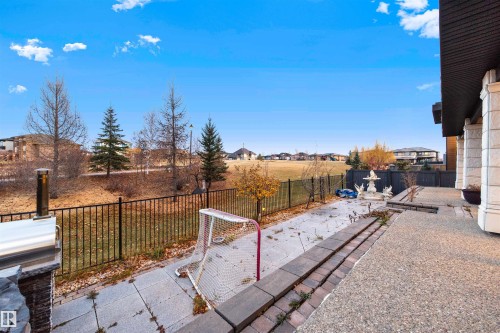 Fenced backyard featuring a patio area and a residential view - 4811 Woolsey Lane, Edmonton, AB - Outdoor