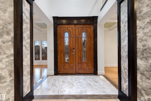 Entrance foyer with baseboards and light marble finish floors - 4811 Woolsey Lane, Edmonton, AB -  Photo Showing Other Room