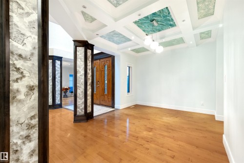 Unfurnished room featuring light wood-style floors and coffered ceiling - 4811 Woolsey Lane, Edmonton, AB - Indoor Photo Showing Other Room