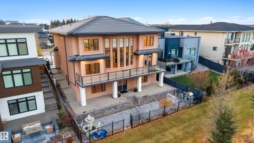 Back of house with a fenced backyard, a patio area, stucco siding, and a residential view - 4811 Woolsey Lane, Edmonton, AB - Outdoor