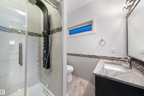 Bathroom featuring a stall shower and vanity - 4811 Woolsey Lane, Edmonton, AB - Indoor Photo Showing Bathroom