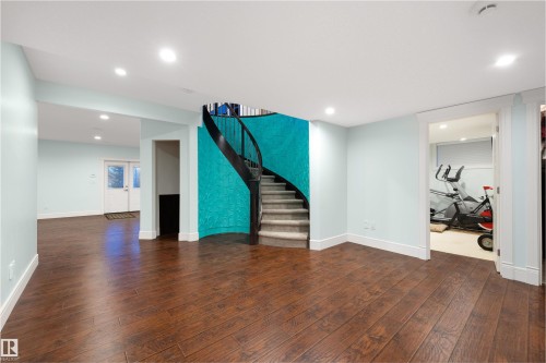 Unfurnished living room with dark wood-type flooring and recessed lighting - 4811 Woolsey Lane, Edmonton, AB - Indoor Photo Showing Other Room