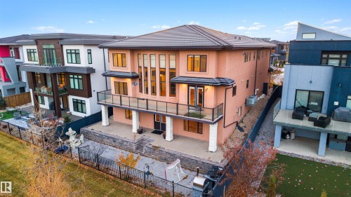 Rear view of house featuring a patio area, a fenced backyard, stucco siding, and a balcony - 4811 Woolsey Lane, Edmonton, AB - Outdoor With Balcony