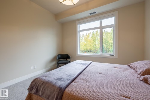 Carpeted bedroom featuring baseboards - 7471 May Common, Edmonton, AB - Indoor Photo Showing Bedroom