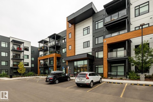View of apartment building / complex featuring uncovered parking - 7471 May Common, Edmonton, AB - Outdoor With Facade