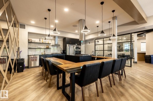 Dining space featuring light wood-style floors and a community bar - 7471 May Common, Edmonton, AB - Indoor Photo Showing Dining Room