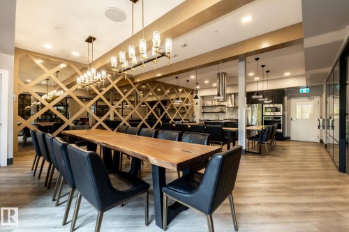 Dining space featuring light wood-style flooring and a chandelier - 7471 May Common, Edmonton, AB - Indoor Photo Showing Dining Room